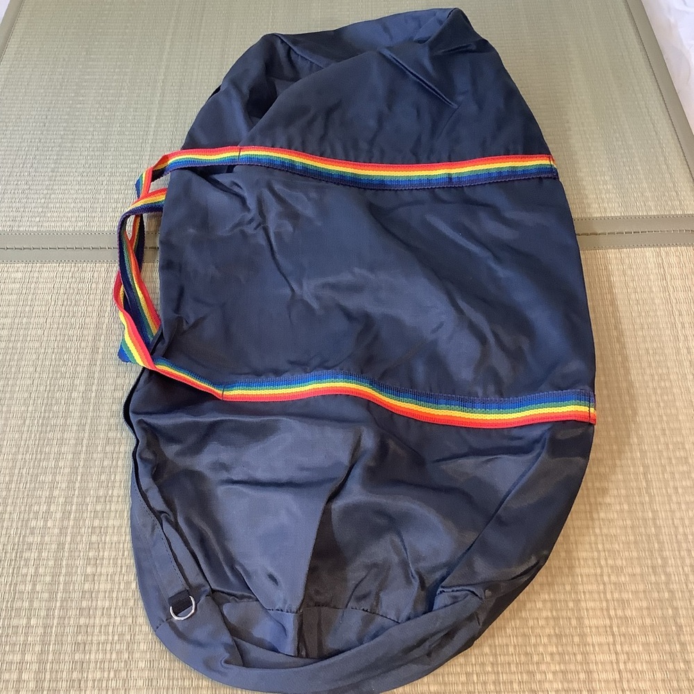 Big blue duffel bag with rainbow stripes handle straps Pride Duffle